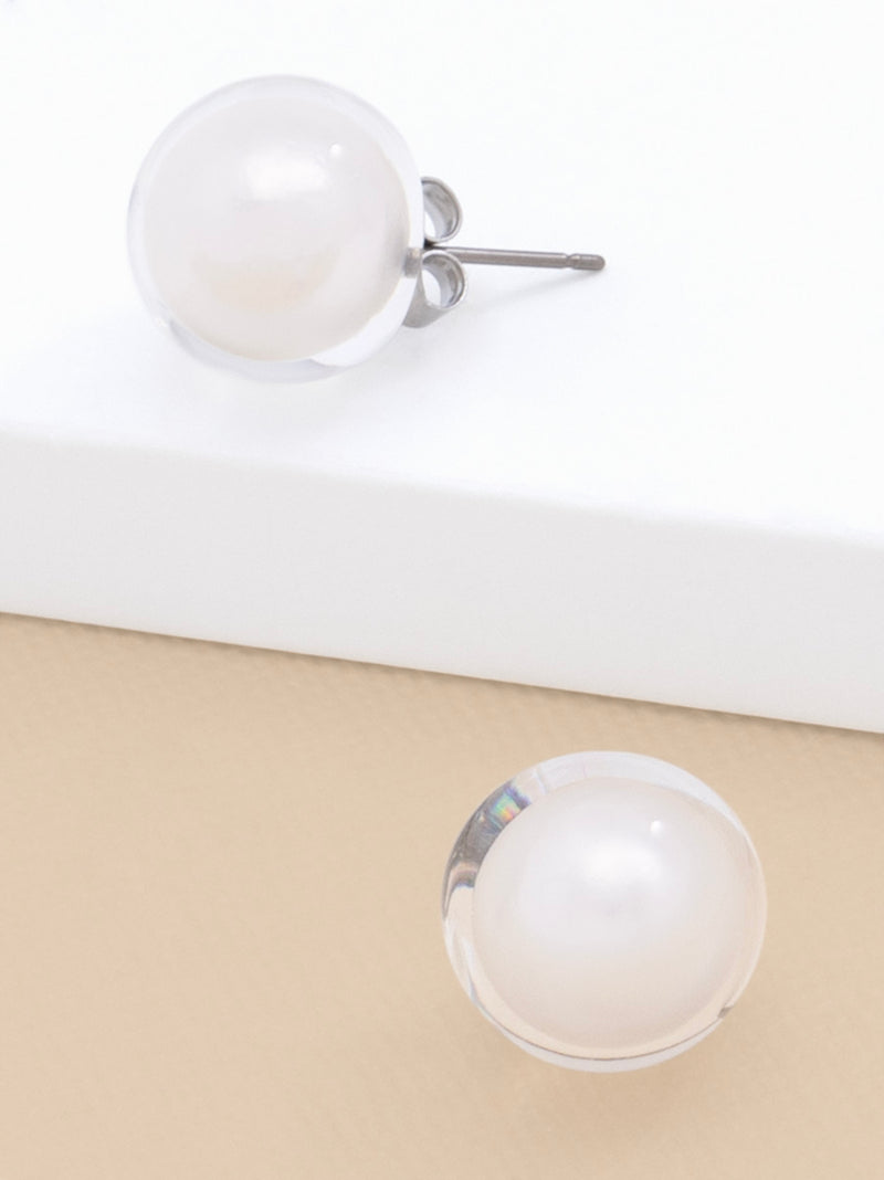 Lucite covered pearl stud earring.